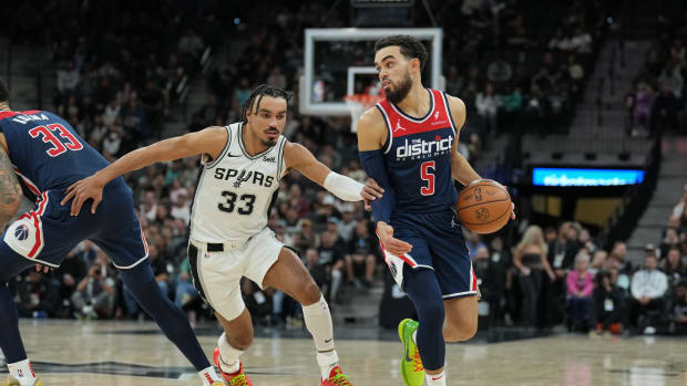 Jan 29, 2024; San Antonio, Texas, USA; Washington Wizards guard Tyus Jones (5) dribbles past San Antonio Spurs guard Tre Jones (33) in the second half at Frost Bank Center.